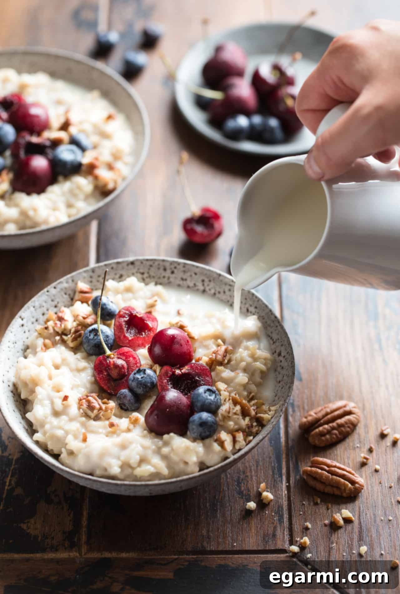 A variety of Brown Rice Breakfast Pudding bowls, topped with different fruits and nuts, ready to eat