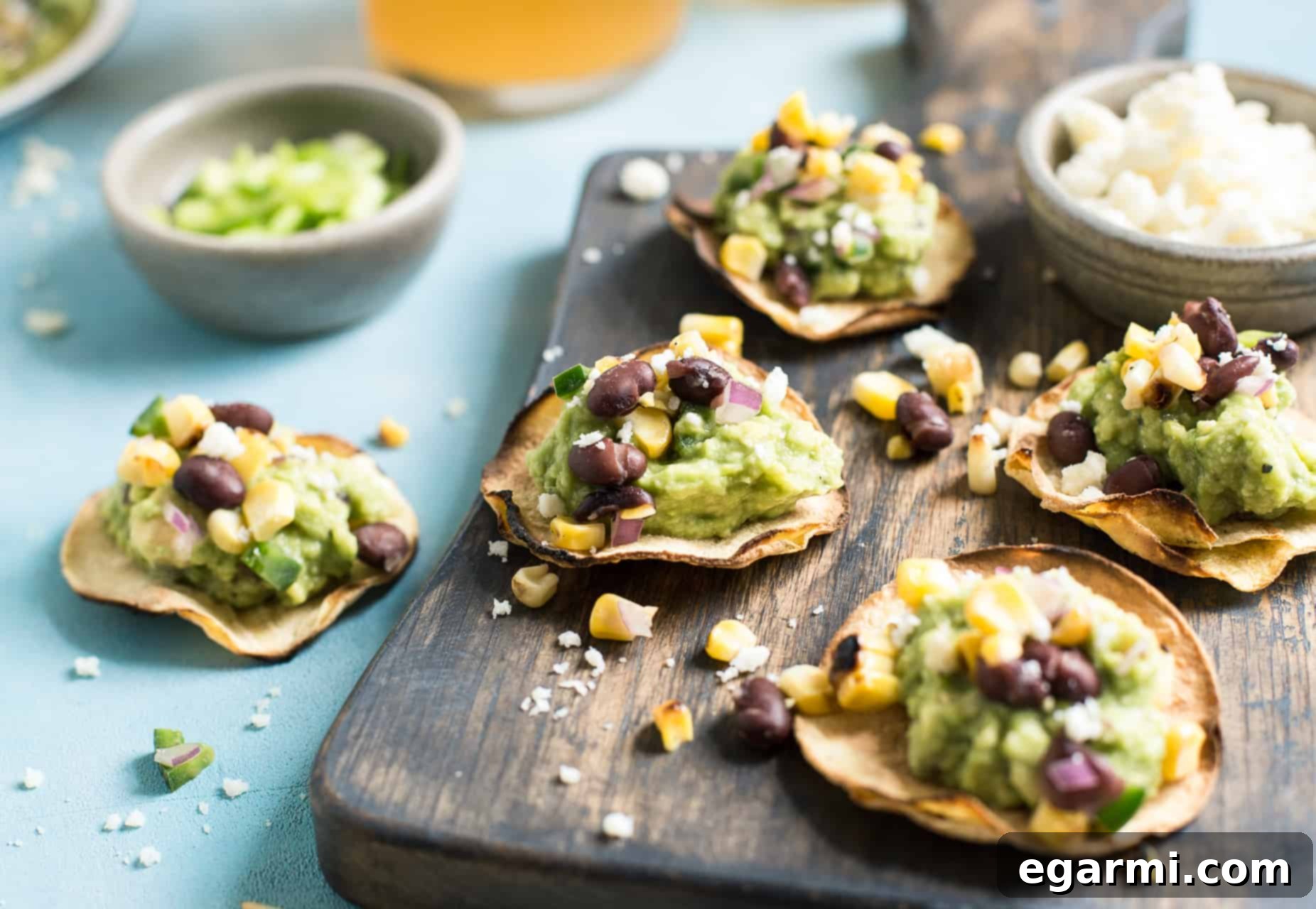 Close-up of a single Grilled Corn Salsa & Guacamole Tostada, ready to be served. Healthy and fresh appetizer idea.