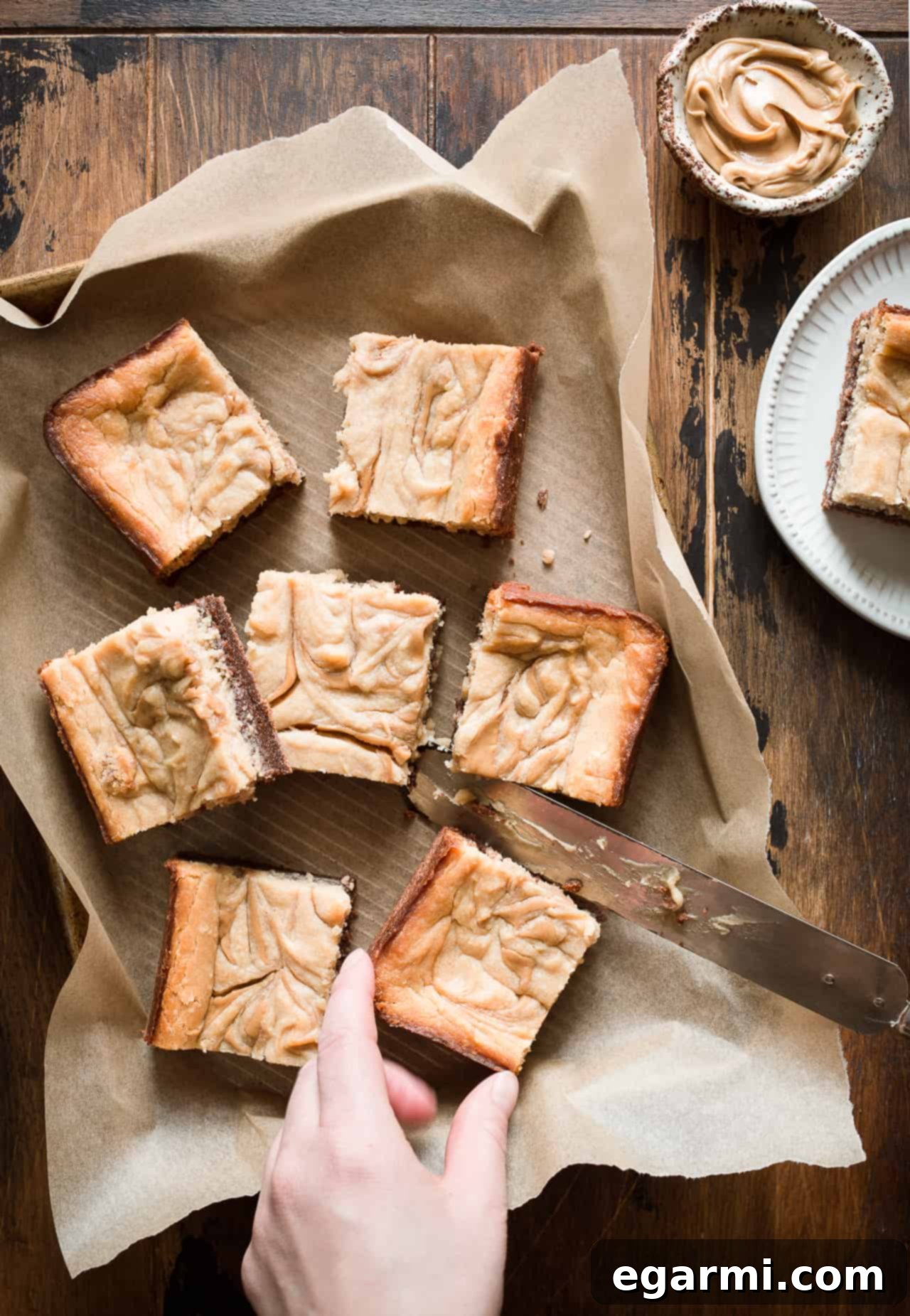 Close-up of a stack of Gluten-Free Peanut Butter Cheesecake Brownies showcasing the distinct brownie and cheesecake layers, ready to be enjoyed
