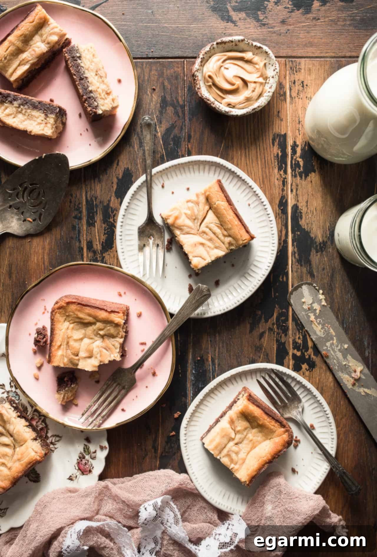 Plate of freshly baked Gluten-Free Peanut Butter Cheesecake Brownies with a fork, emphasizing the soft texture and inviting swirled design