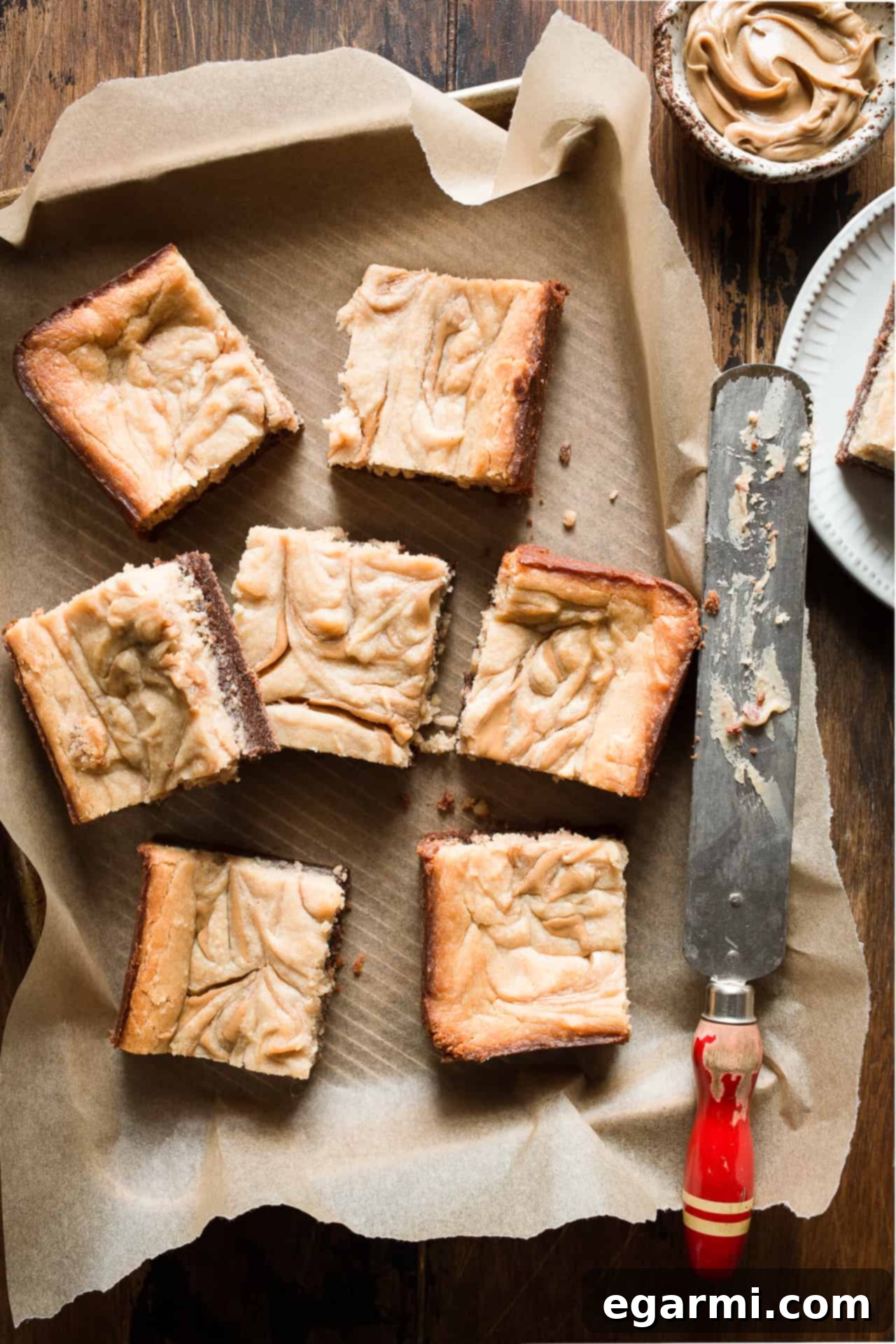 A closer view of a single Gluten-Free Peanut Butter Cheesecake Brownie, showcasing the thick brownie base and the beautifully swirled peanut butter cheesecake topping