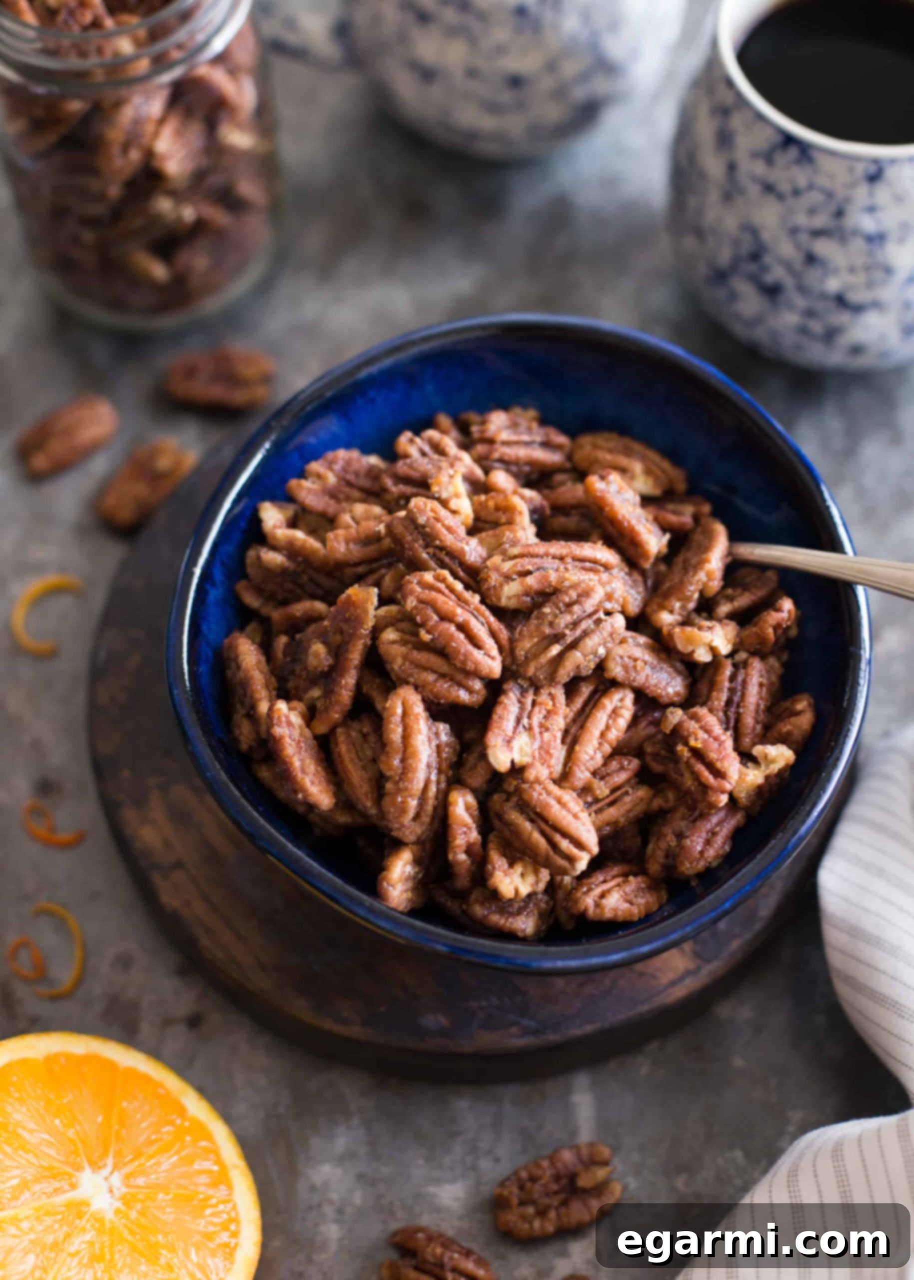 Maple-Orange Roasted Pecans | This naturally sweetened, gluten-free snack is bursting with the flavors of maple and orange, arranged beautifully on a baking sheet.