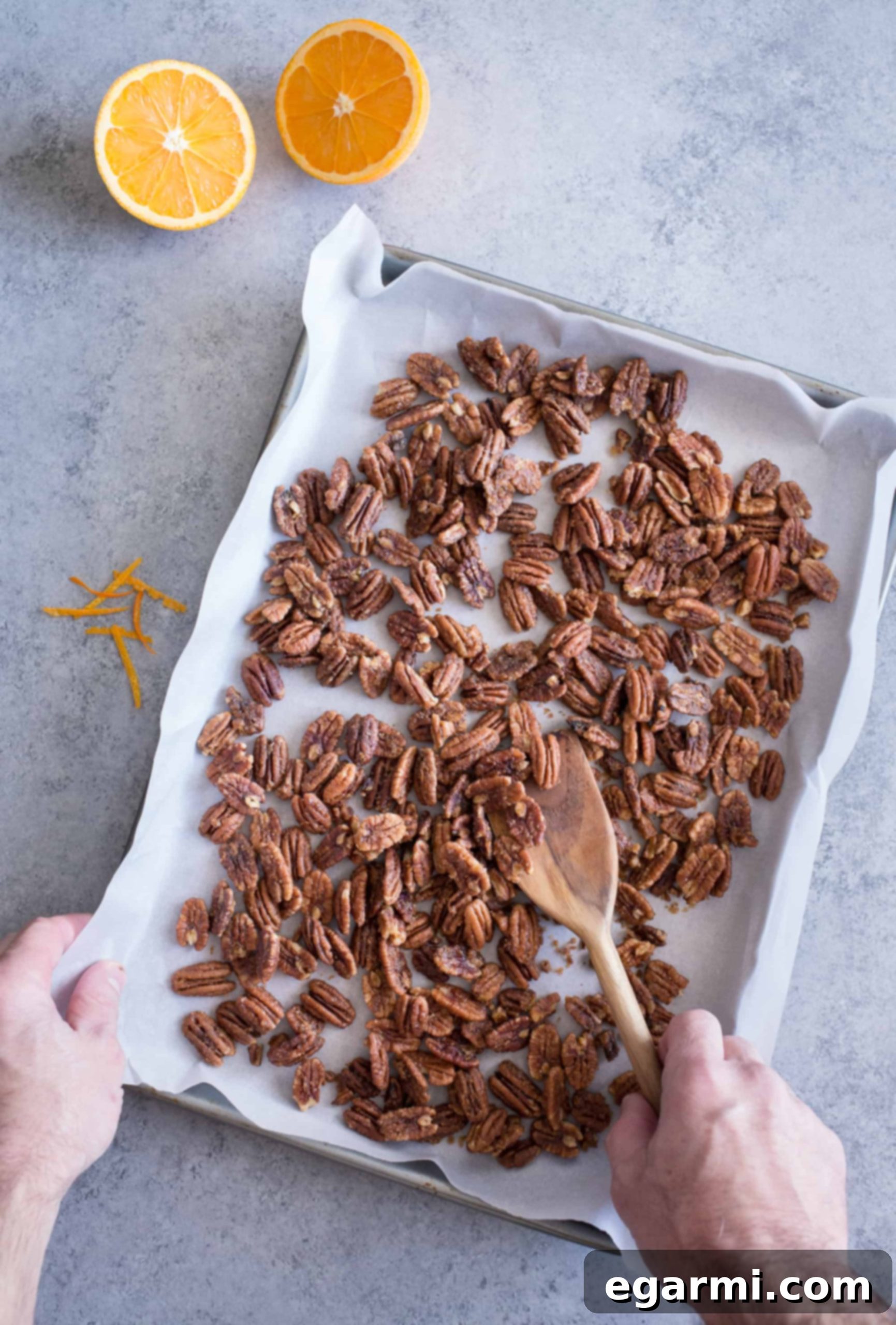 Close-up of roasted pecans, showcasing their golden-brown hue and glistening maple-orange coating.