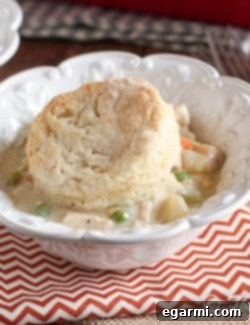 A freshly baked Chicken and Biscuit Pot Pie Casserole, showcasing golden biscuits and a rich filling, ready to serve.