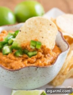 A bowl of Smoky Chipotle Hummus, garnished and ready to serve.