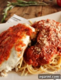 Signature Chicken Parmesan 2 A serving of Classic Chicken Parmesan with melted mozzarella and marinara, ready to be enjoyed.