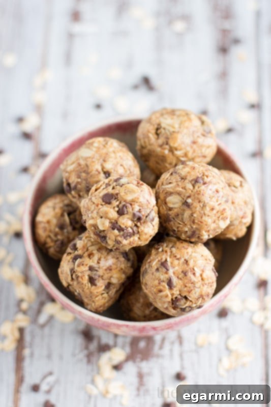 Peanut Butter Oatmeal Bites 7 A finished batch of Peanut Butter Oat Balls in a container, separated by wax paper.