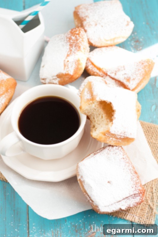 Fluffy Buttermilk Beignets with powdered sugar, ready to be enjoyed