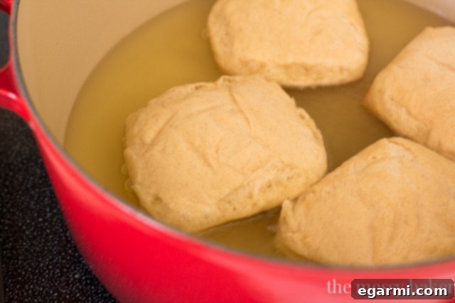 Canola oil heating in a cast iron pan, ready for frying beignets