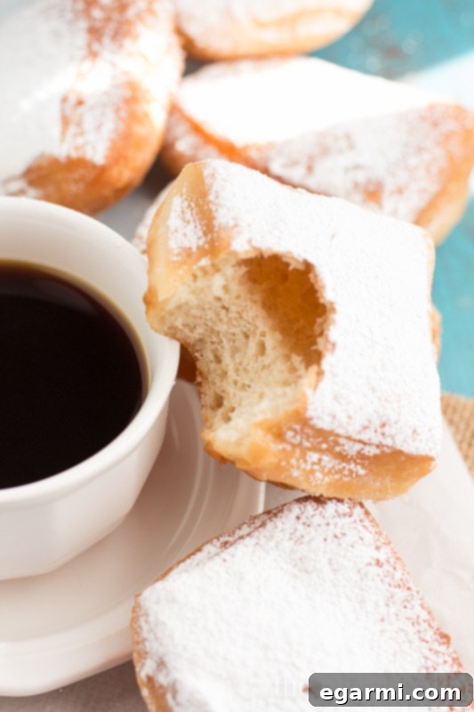 Plate of golden, perfectly fried Buttermilk Beignets dusted with sugar