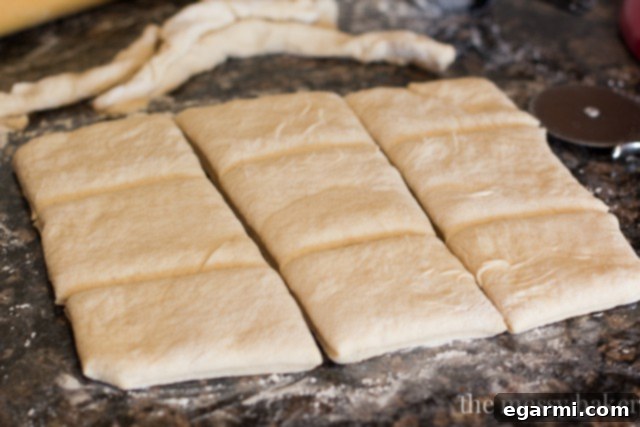 Cutting the rolled-out buttermilk beignet dough into uniform squares