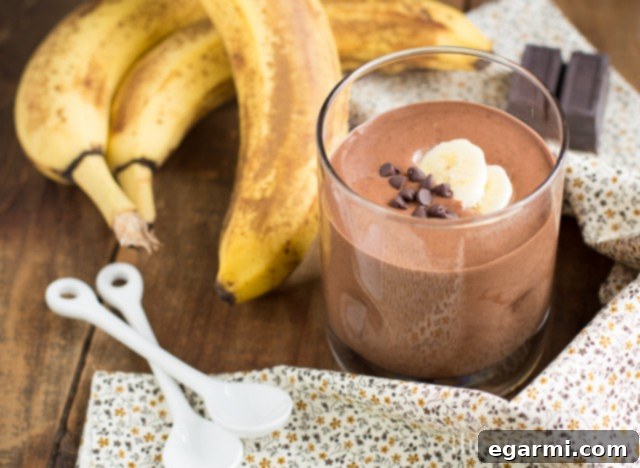 Chocolate Peanut Butter Banana Blender Pudding with a spoon, highlighting its thick and creamy texture.
