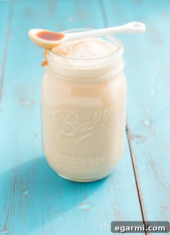 Swirling Delicious Homemade Caramel Macchiato Coffee Creamer into a Cup of Coffee