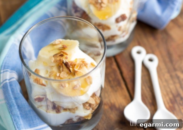Overhead shot of two delicious Banana Bread Parfaits side-by-side, garnished and ready to be enjoyed as a satisfying, protein-rich meal