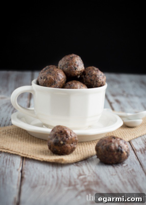 A person relaxing with a magazine, a cup of coffee, and a few Cherry Pie Energy Balls on a side table.