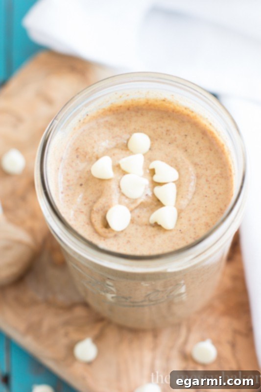 Close-up view of creamy white chocolate cinnamon almond butter, showcasing its texture