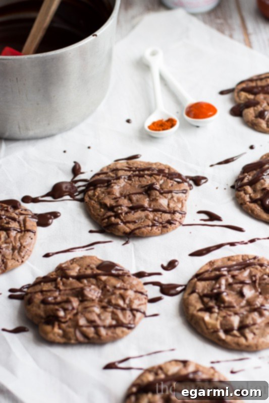 Ingredients for Sriracha Ganache in a bowl: dark chocolate, Sriracha sauce, and a pinch of cayenne pepper, ready to be combined with hot cream.