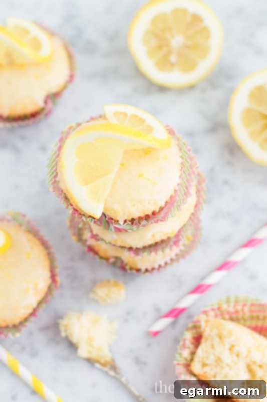 Lemon Glaze being drizzled over warm Lemon Cupcakes