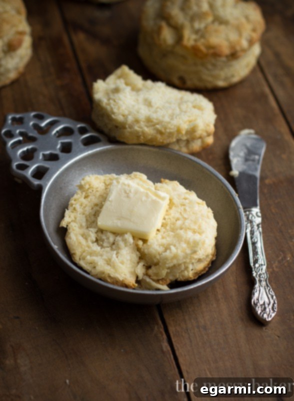 Stack of fluffy, tender buttermilk biscuits, highlighting their impressive height and flaky texture.