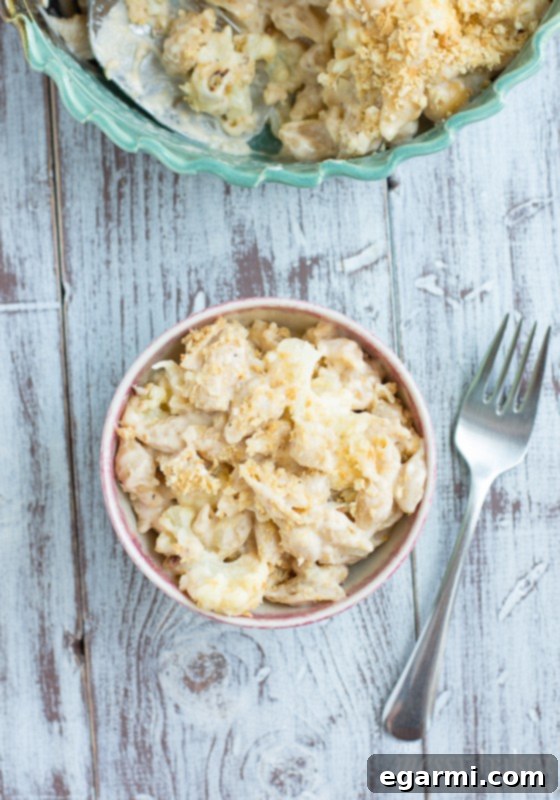 Adding roasted cauliflower to the creamy cheese sauce