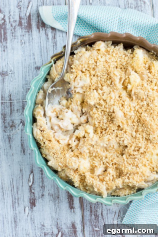 Serving spoonful of creamy roasted cauliflower mac and cheese