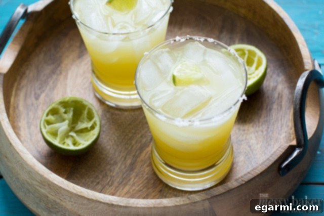 Fresh limes being juiced for a pineapple margarita