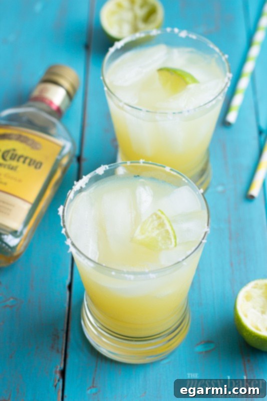 Finished Pineapple Margarita in a glass with a lime wedge