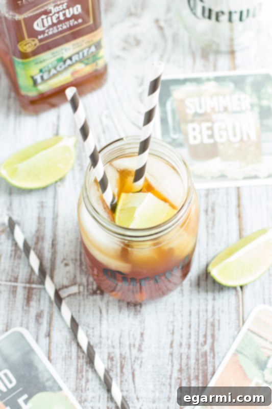 Glass of Jose Cuervo Teagarita with ice, lime, and a straw, ready for a party.