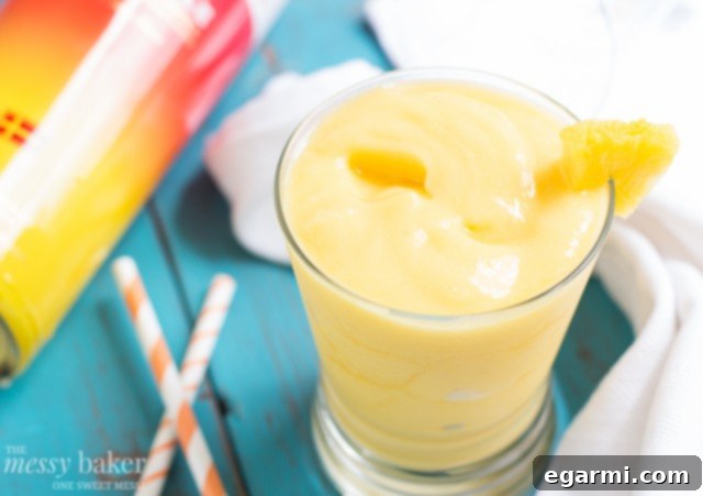 Fresh Ingredients for a Pineapple Mango Slush Cocktail on a Kitchen Counter
