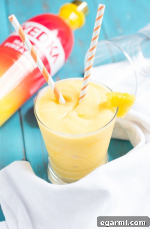 Woman Relaxing Outdoors and Enjoying a Pineapple Mango Slush Cocktail