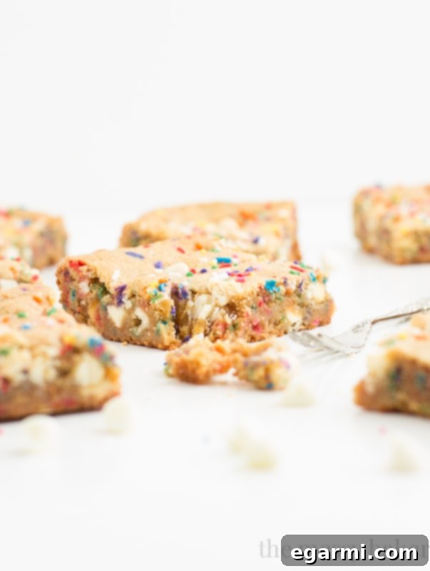 Warm Malted Milk Funfetti Blondies fresh out of the oven, highlighting their irresistible gooeyness.