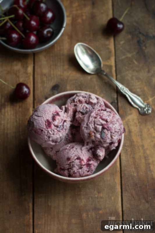 Rich and creamy homemade cherry ice cream with toasted almonds, perfect for a summer dessert.