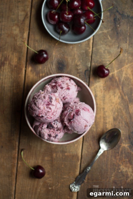 Scoops of Toasted Almond & Cherry Ice Cream served in a bowl, ready to be enjoyed.