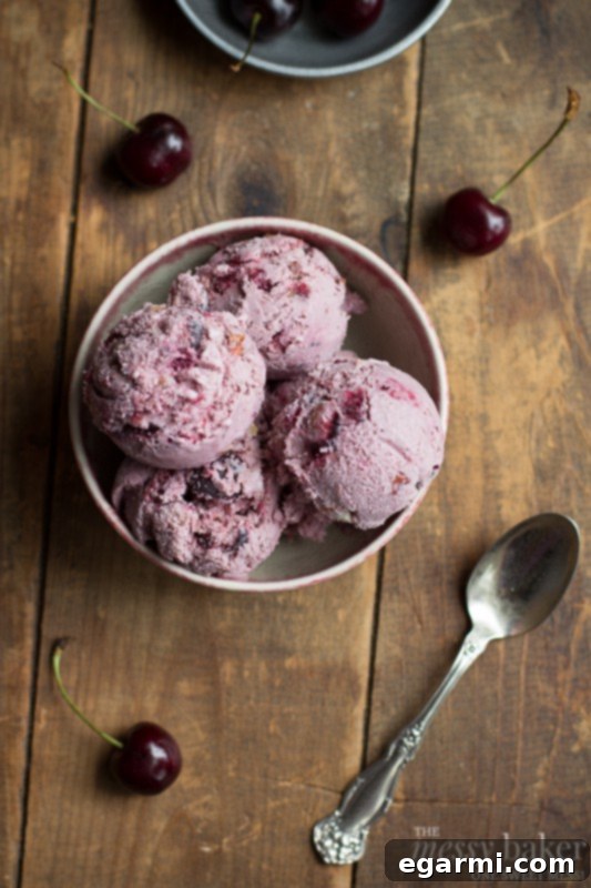 A close-up of the delicious homemade Toasted Almond & Cherry Ice Cream, ready for serving.