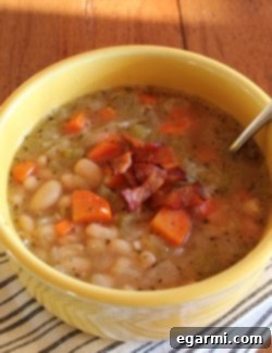 Hearty Homestyle White Bean Soup 10 A beautiful bowl of Rustic White Bean Soup topped with crispy bacon.