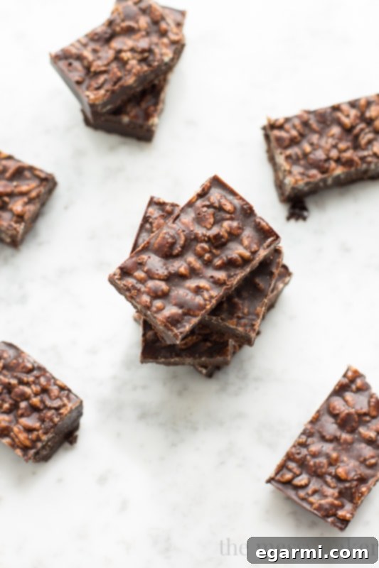 A close-up of a square of Carob Peanut Butter Freezer Fudge, showcasing its rich brown color and a perfectly smooth texture, ready to be enjoyed as a healthy vegan and gluten-free snack.