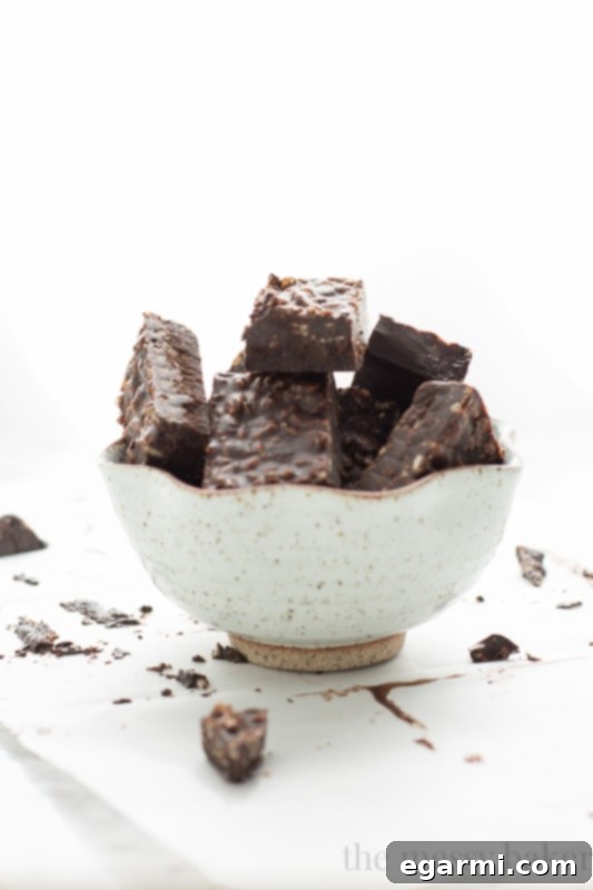 Several squares of Carob Peanut Butter Freezer Fudge neatly arranged, displaying their uniform shape and the visible crunch from rice crisp cereal, indicating a delightful texture contrast.