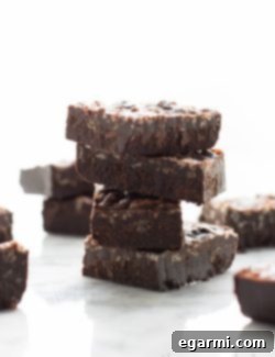 A close-up shot of two squares of Carob Peanut Butter Freezer Fudge, showcasing the rich texture and delicious appeal of this healthy vegan dessert.
