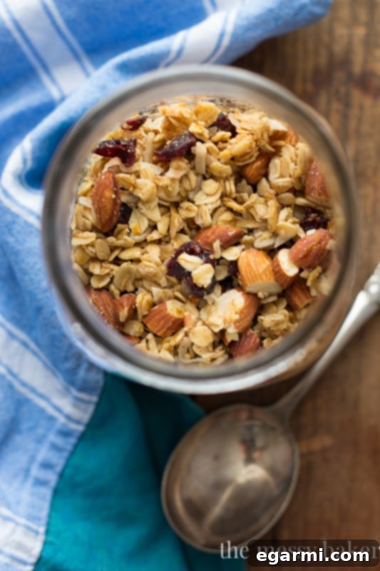 Cranberry Orange Granola baking on a sheet pan