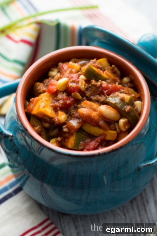 Close-up of a rustic bowl of Easy Harvest Chili, showcasing its rich texture and colorful ingredients.