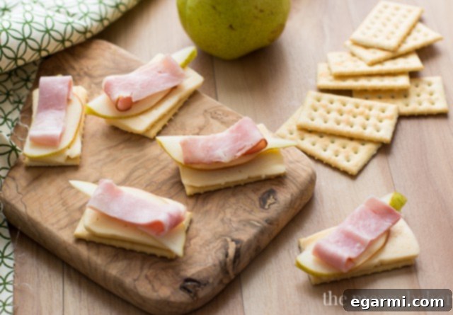 Smoked Ham, Havarti, and Pear Cracker Bites 6 Assembling Havarti, Pear, and Smoked Ham Cracker Appetizers on a Platter
