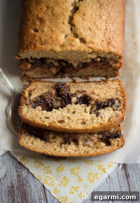 Freshly baked loaf of Nutella & Toasted Pecan Swirl Banana Bread, ready for slicing.