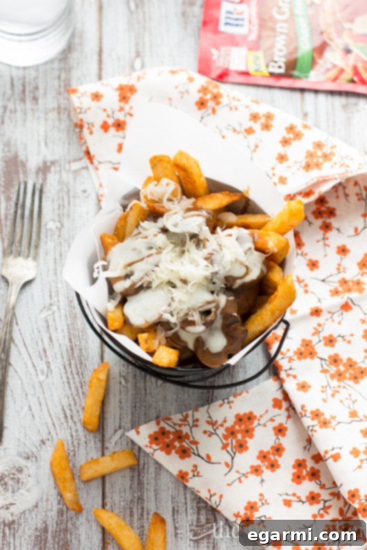 Delicious Gluten-Free Mushroom Swiss Poutine with rich gravy and cheese.
