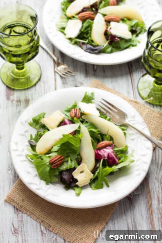Elevate your fall table with this gourmet Poached Pear and Brie Salad, featuring tender wine-poached pears, creamy brie, and a tangy balsamic vinaigrette.