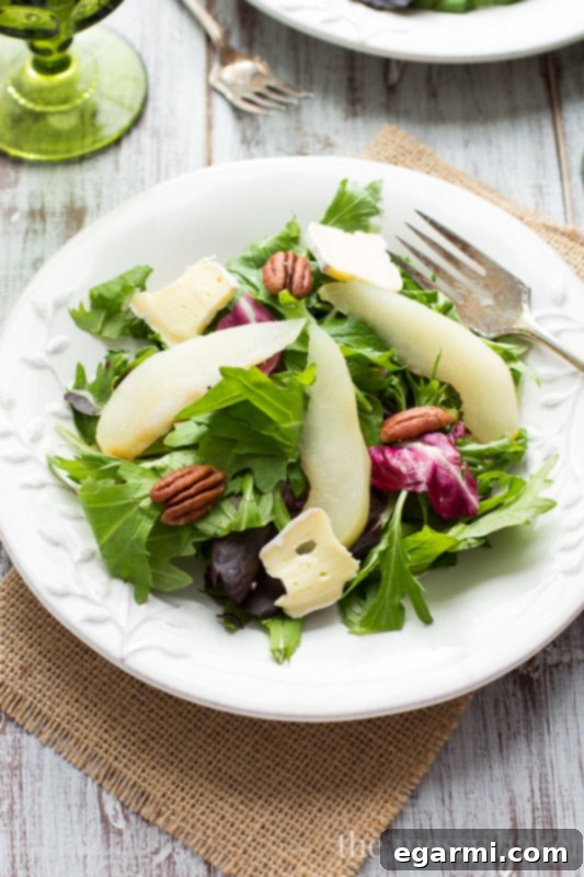 A delicious poached pear dessert, drizzled with the flavorful poaching liquid.