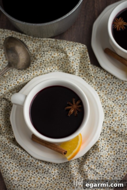 Cozy Pomegranate Mulled Wine for Sunday Supper 6 Pomegranate Mulled Wine | Spices and orange slices for a festive drink