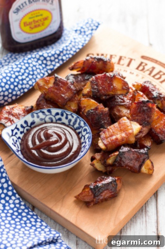 Crispy potato wedges wrapped in smoky bacon and glazed with Sweet Baby Ray's Barbecue Sauce, perfect for football parties, holiday appetizers, and special gatherings.
