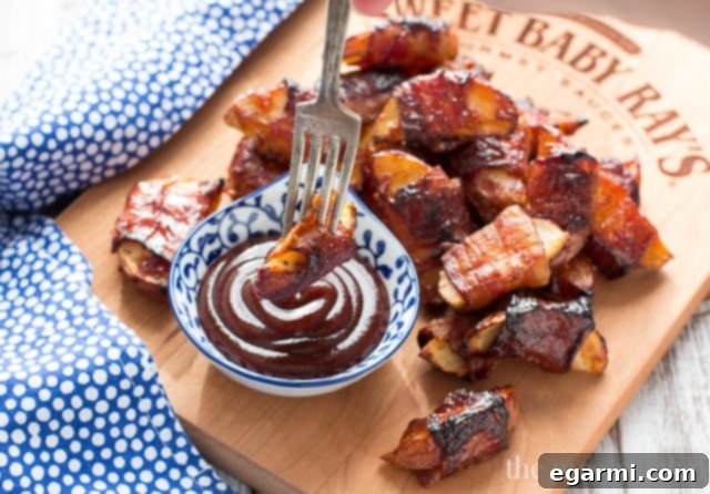 A serving of freshly baked bacon-wrapped barbecue potato wedges on a rustic wooden board, garnished with fresh herbs, ready for a party.