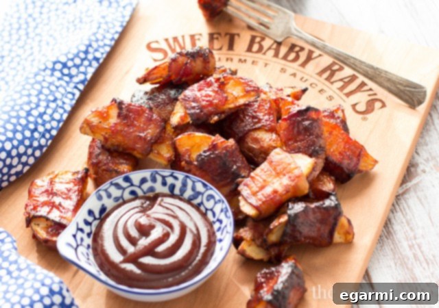 Serving suggestion: Bacon-wrapped barbecue potato wedges presented with a side of extra barbecue dipping sauce for an enhanced flavor experience.