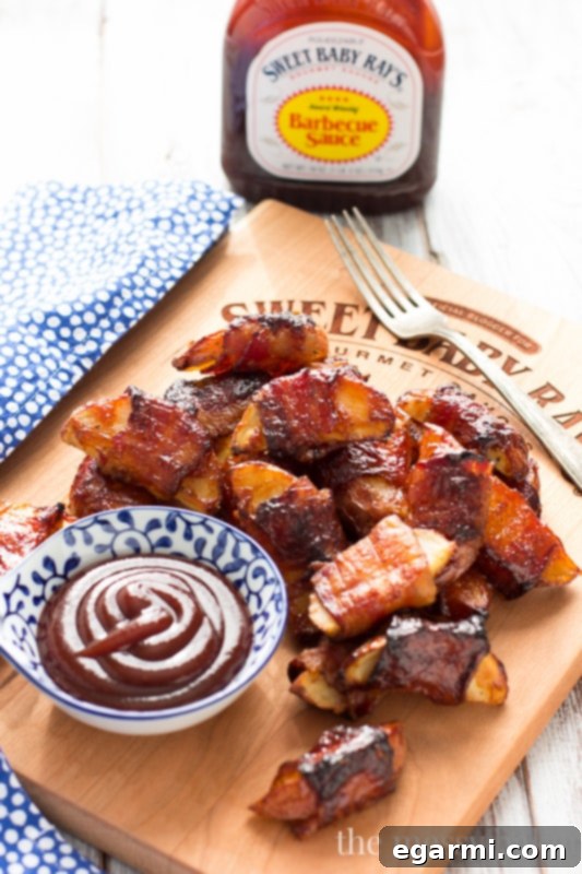A mouth-watering image of crispy bacon-wrapped barbecue potato wedges, showcasing their appealing golden-brown color and perfect texture.